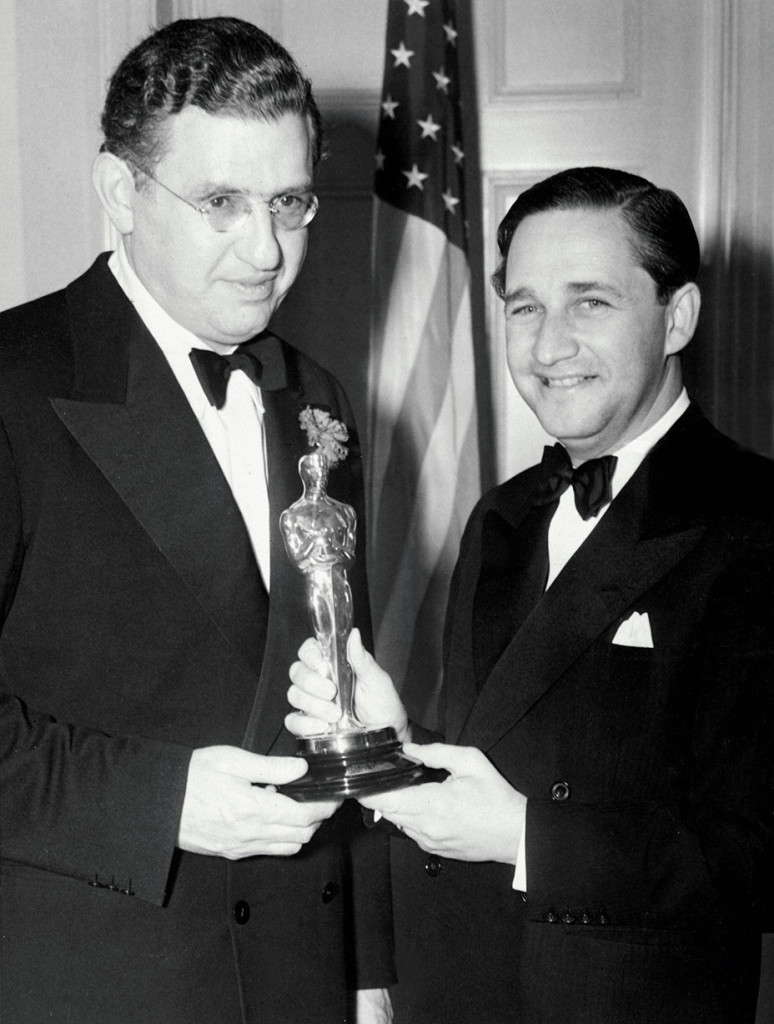 DAVID O. SELZNICK (Best Picture, GONE WITH THE WIND) picks up his Oscar from MERVYN LE ROY, 3/2/40